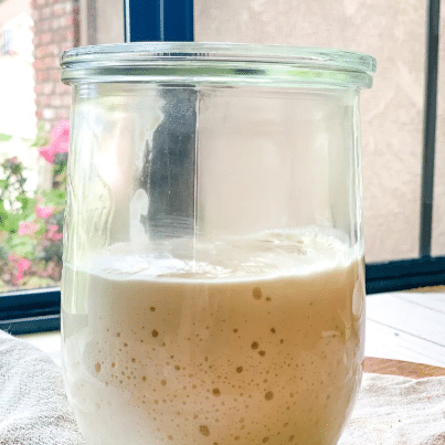 Jar of sourdough starter bubbling.