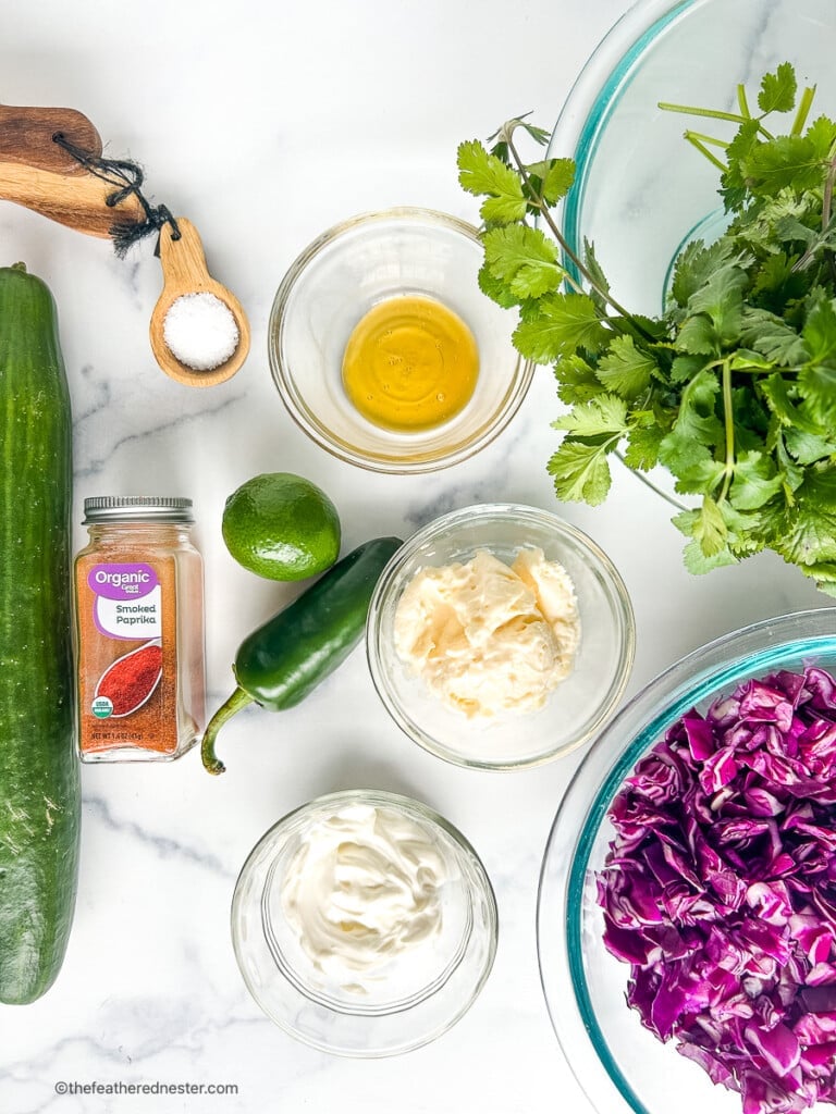 Ingredients in small prep bowls and on a counter top to make summer coleslaw.