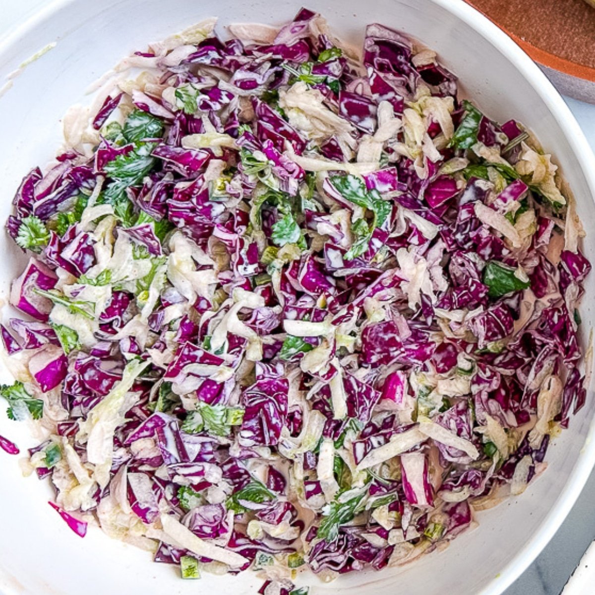 Overhead: taco slaw in a large white bowl.