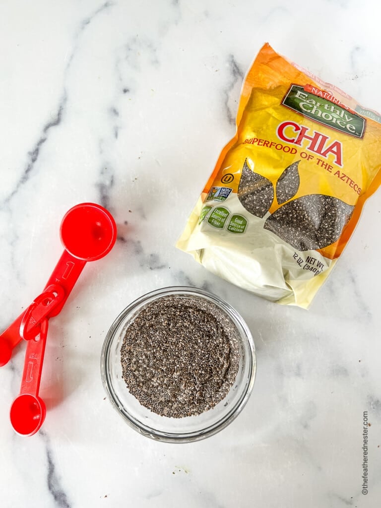 Package of chia seeds with a small bowlful next to it.