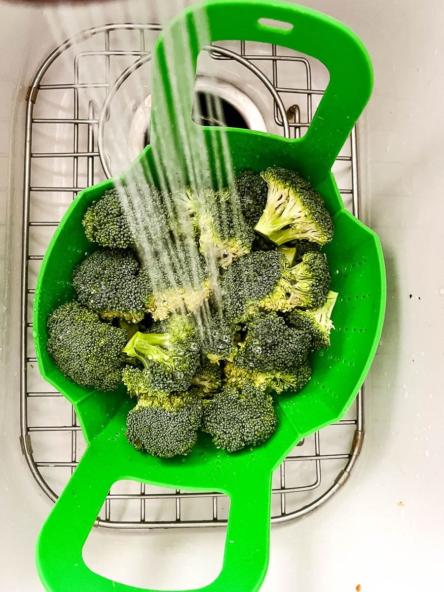 Shocking cooked green vegetables with cold water to stop the cooking.