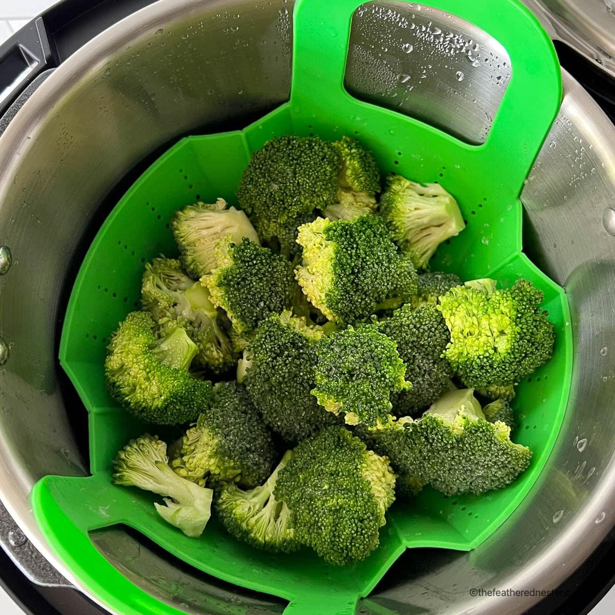 Instant Pot steamed broccoli inside the pressure cooker steaming basket.