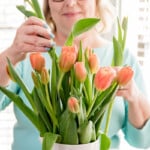 Renae arranging a vase of tulips