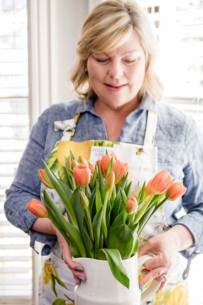 Renae holding a vase of tulips
