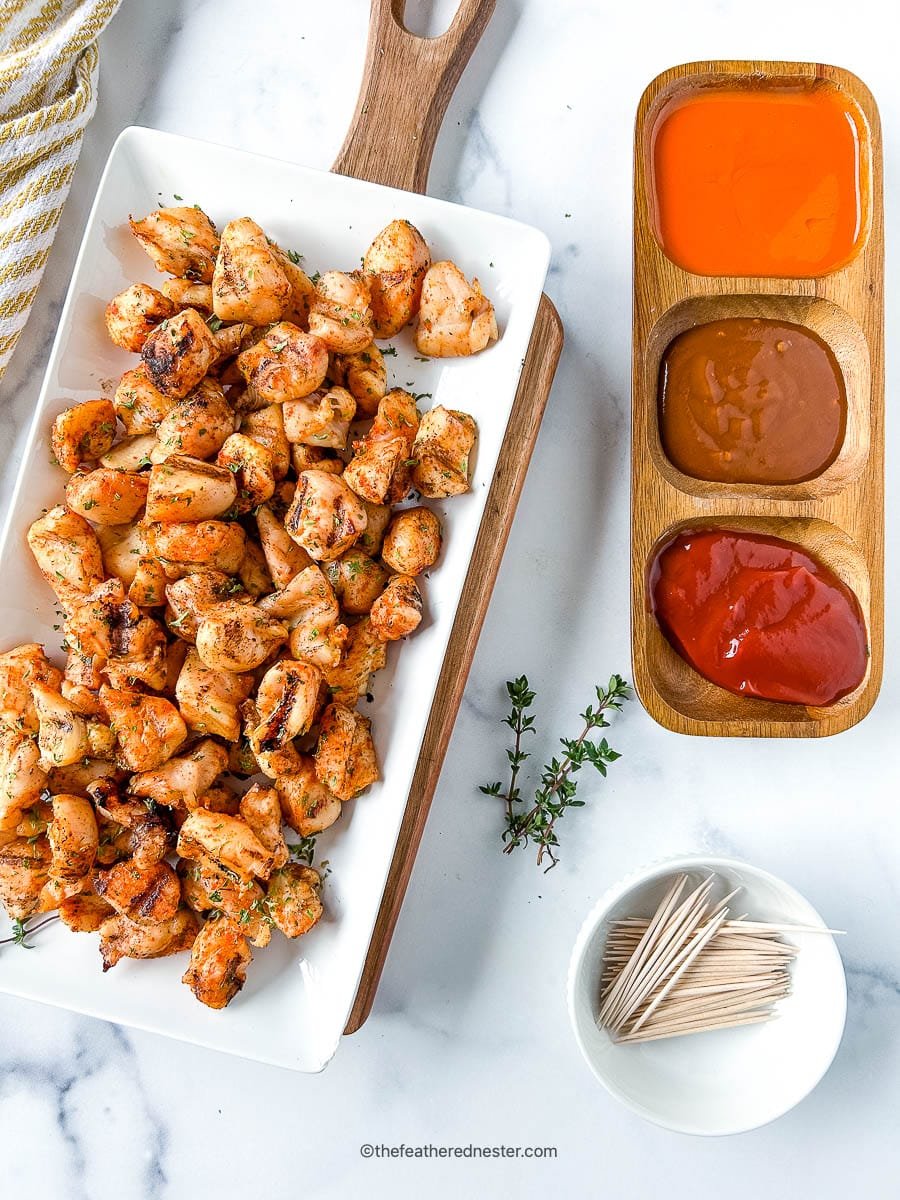 Platter of grilled nuggets and Chick Fil A dipping sauces.