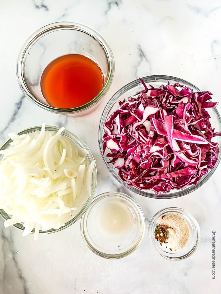 Red cabbage, onion, vinegar, sugar, and seasonings for taco slaw recipe.