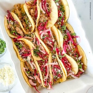 Serving dish full of pork tacos.