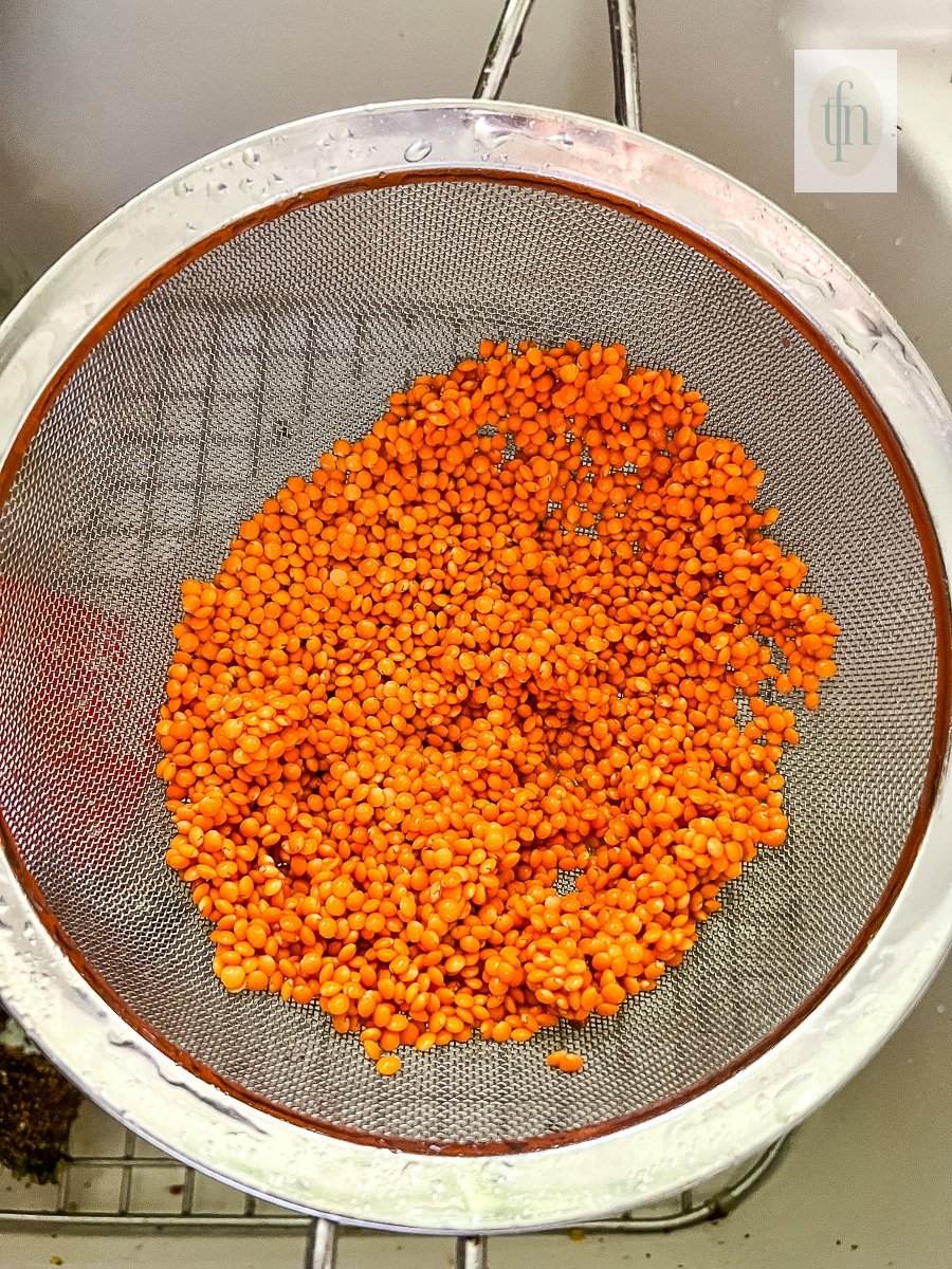 Straining pulses through a fine mesh sieve.