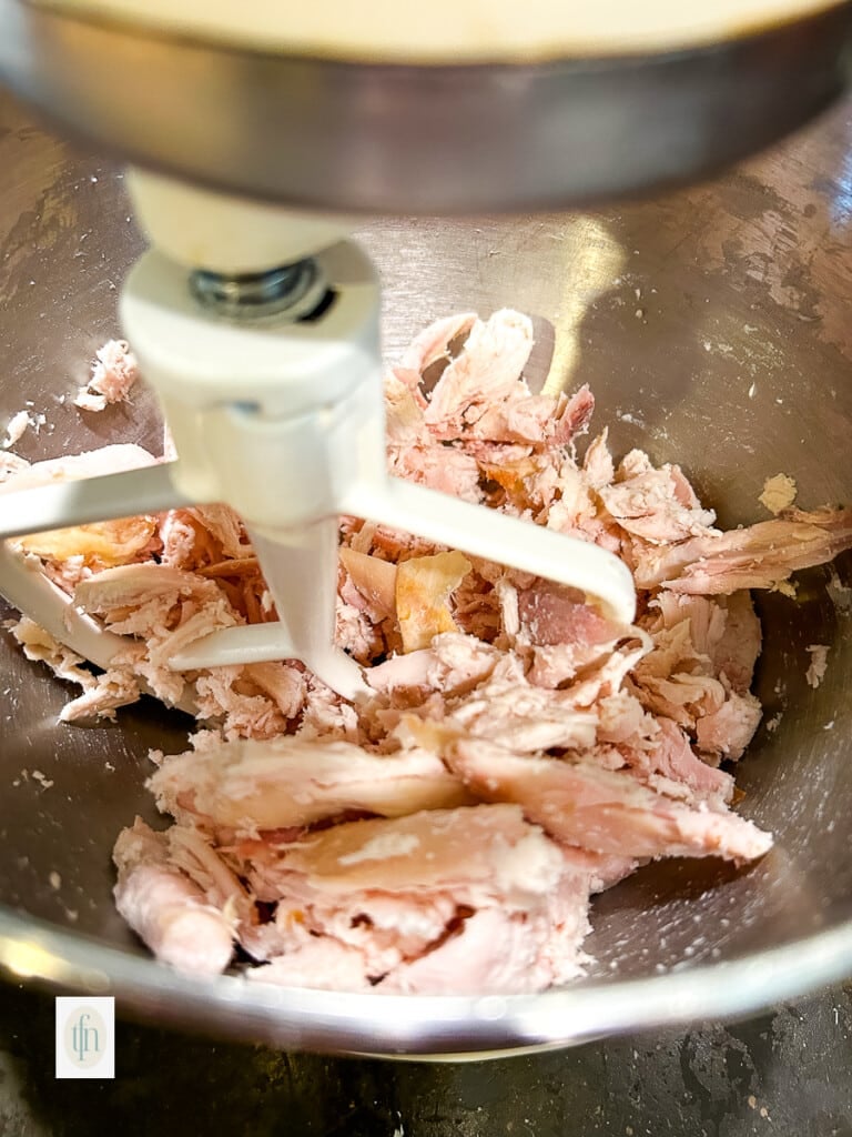 Shredding rotisserie chicken in a stand mixer.