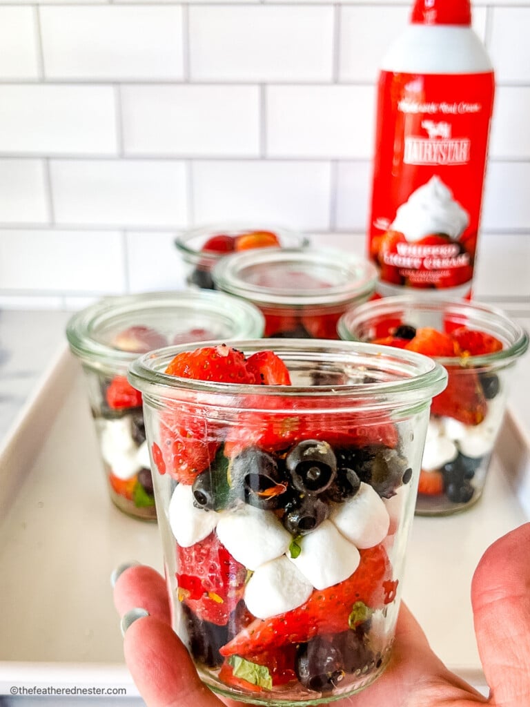 4th of July strawberry blueberry salad in small jars.