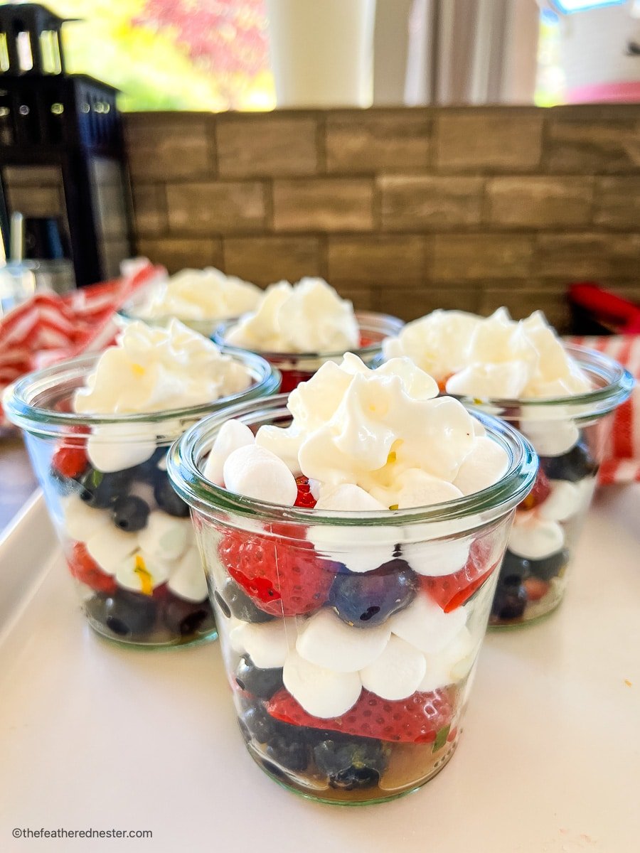 Red white and blue salad in small glass cups.