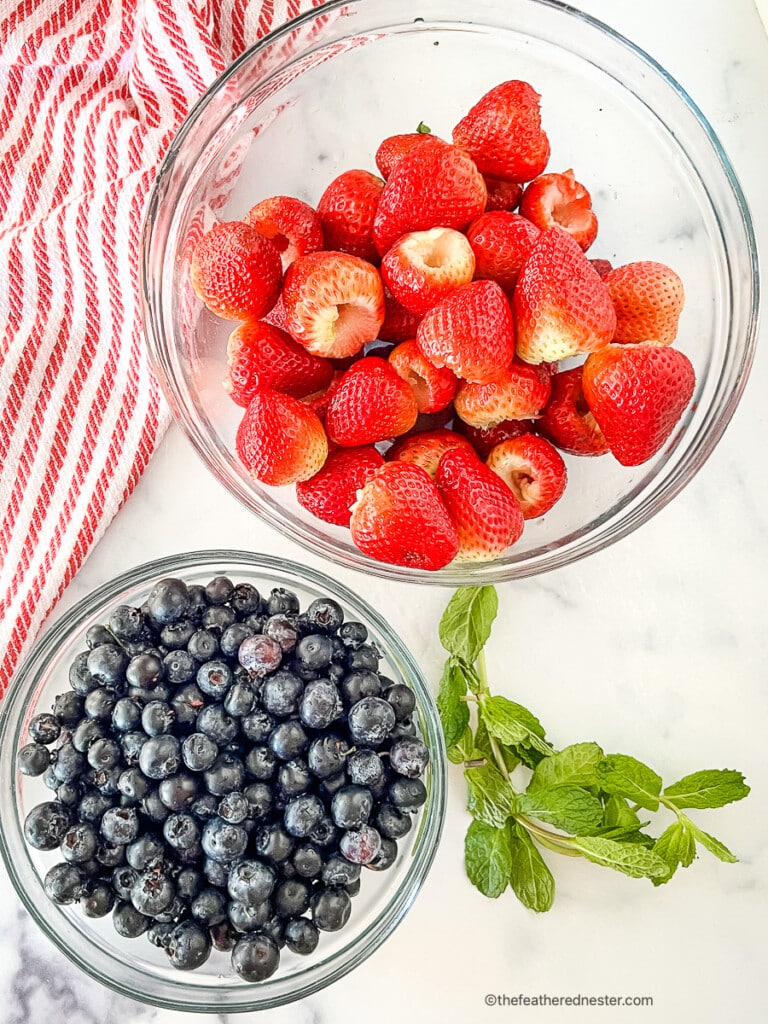 Bowls of blueberries and strawberries for an easy fruit salad.