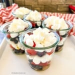 Small cups filled with mini marshmallows and red and blue berries.