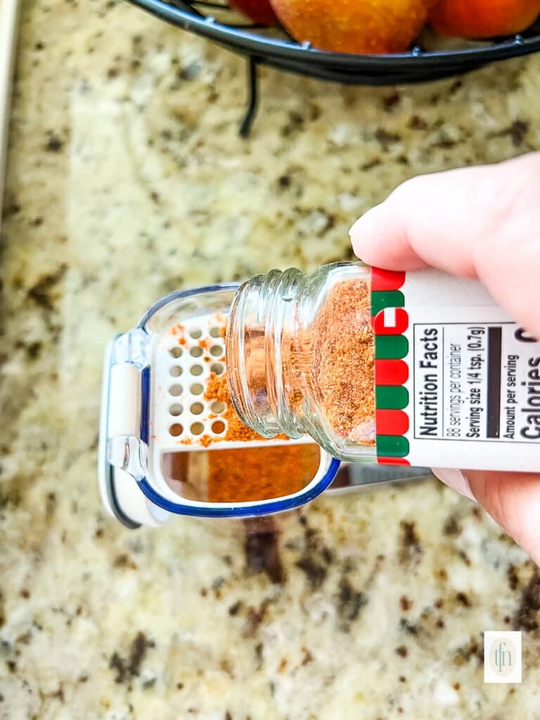 Refilling a spice shaker.