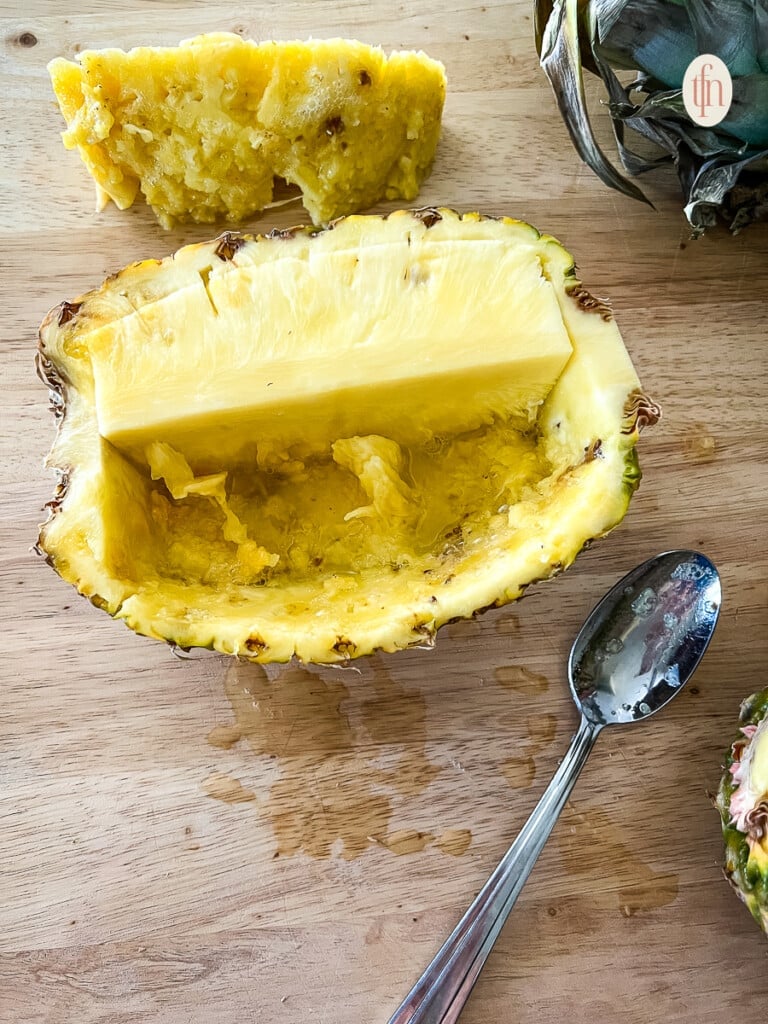 A partially cut pineapple bowl.