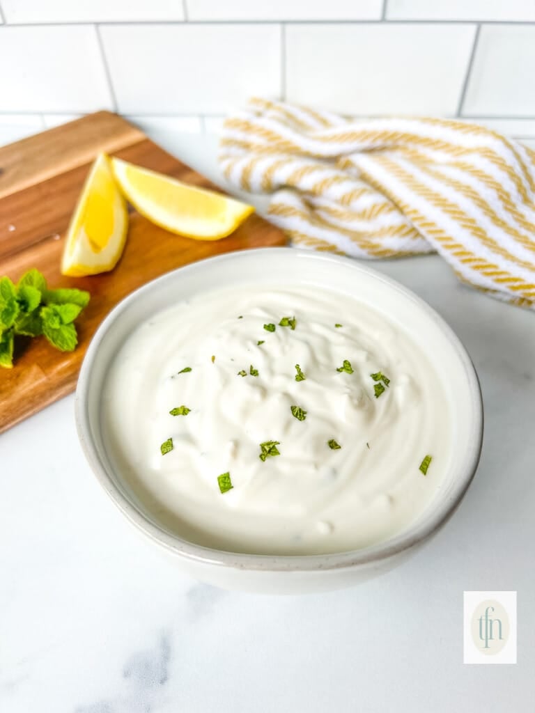 Dish filled with creamy garlic yogurt sauce.
