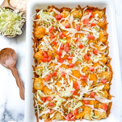 Cheeseburger tater tot casserole in a white baking dish, ready to serve.