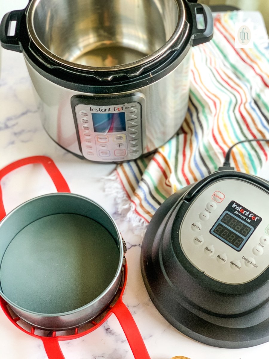 6-quart Instant Pot Duo with air frying lid accessory next to a springform pan and silicone sling.