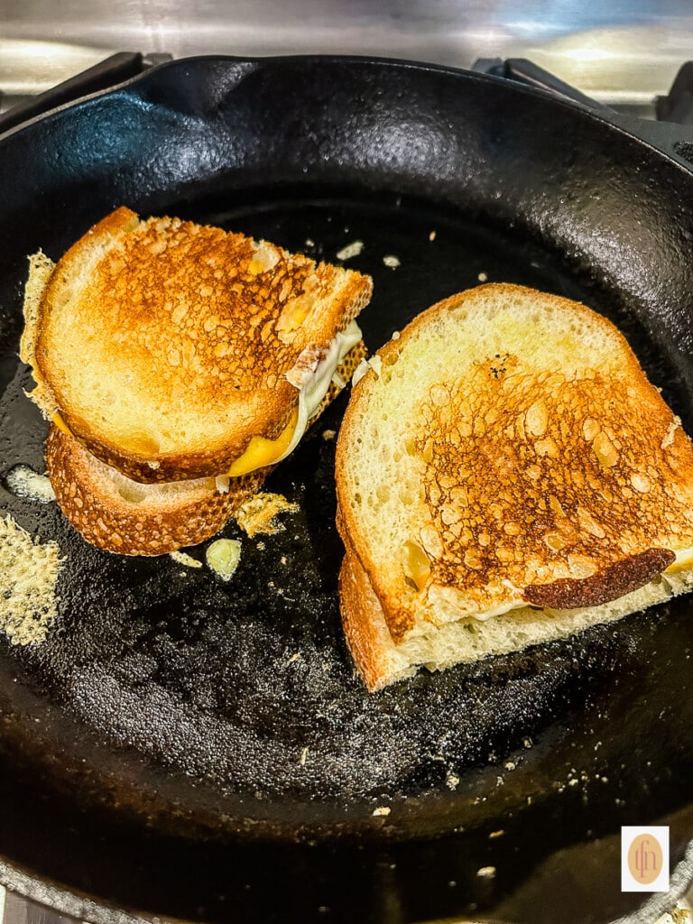 Cooking sandwiches in a cast iron skillet.