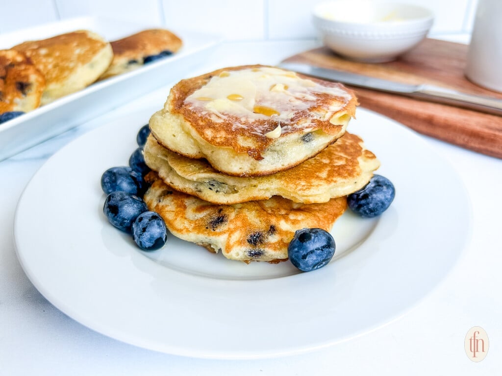 Short stack of blueberry pancakes made with muffin mix.