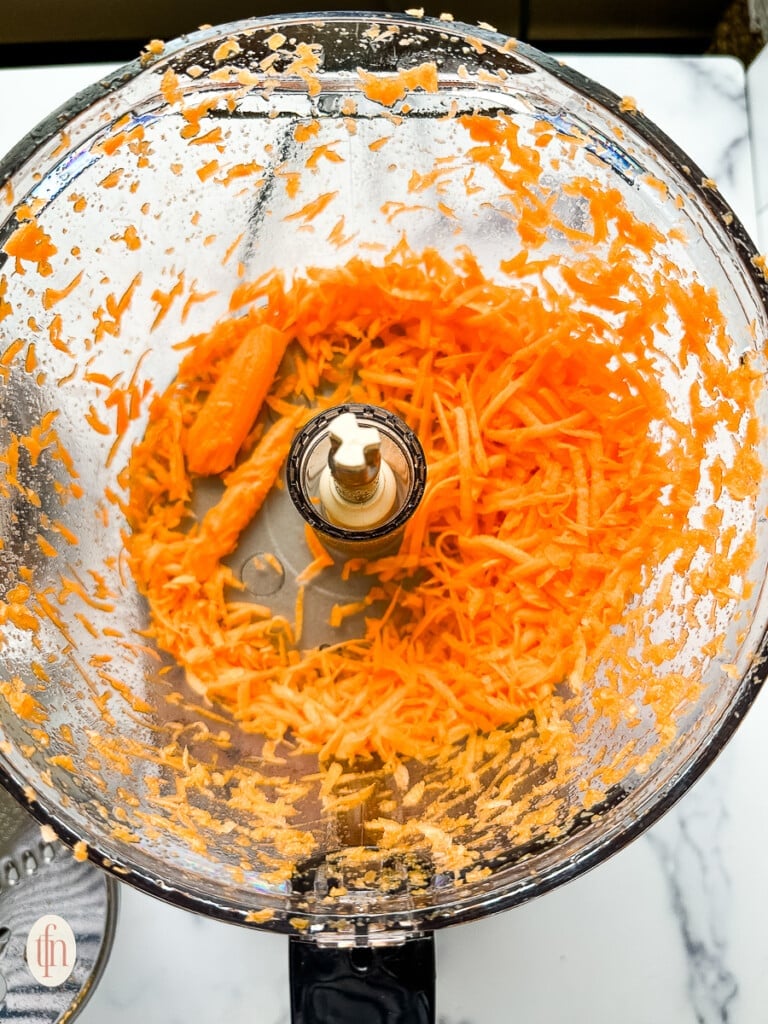 shredded carrots in a food processor.
