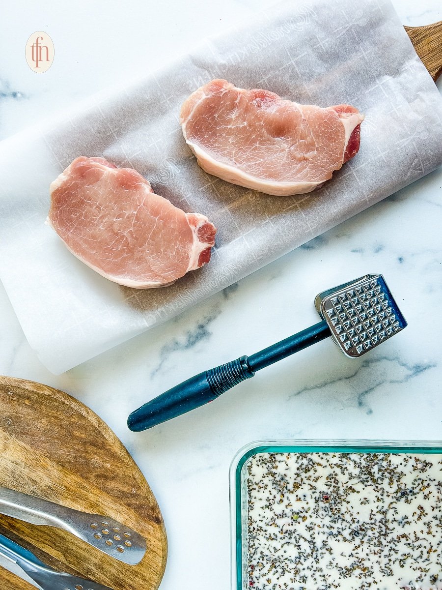 Showing how to tenderize pork chops with brine and a tenderizing mallet.