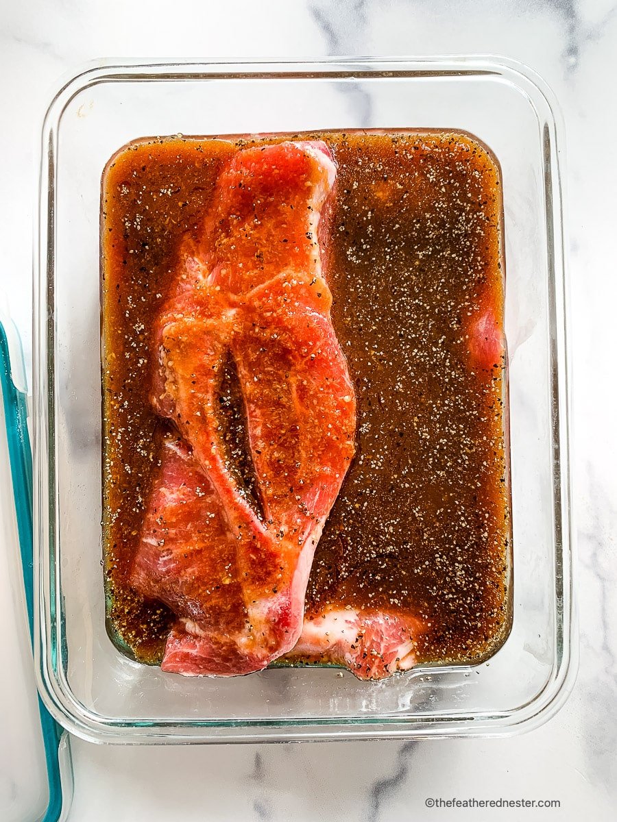 Tenderizing pork chops with marinade.