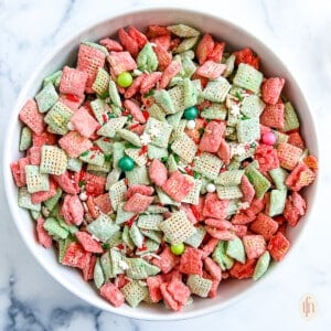 Bowl with candy coated cereal with sprinkles and other small festive candies on top.