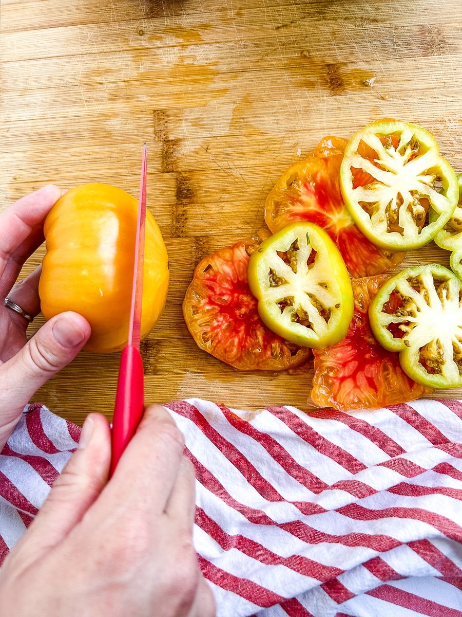 Using a serrated knife to slice tomatoes.