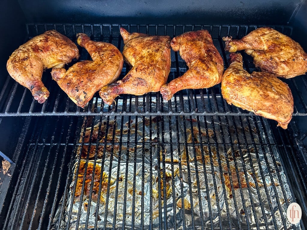 Smoking chicken on the top rack of a smoker.