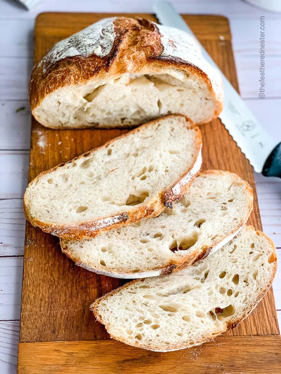 Slices of sourdough garlic bread on a cutting board.