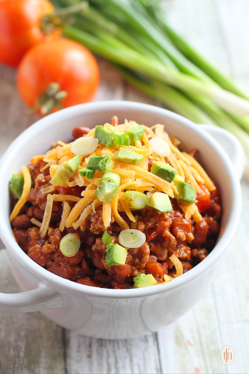 Serving of ground beef and kidney bean stew in a white bowl.