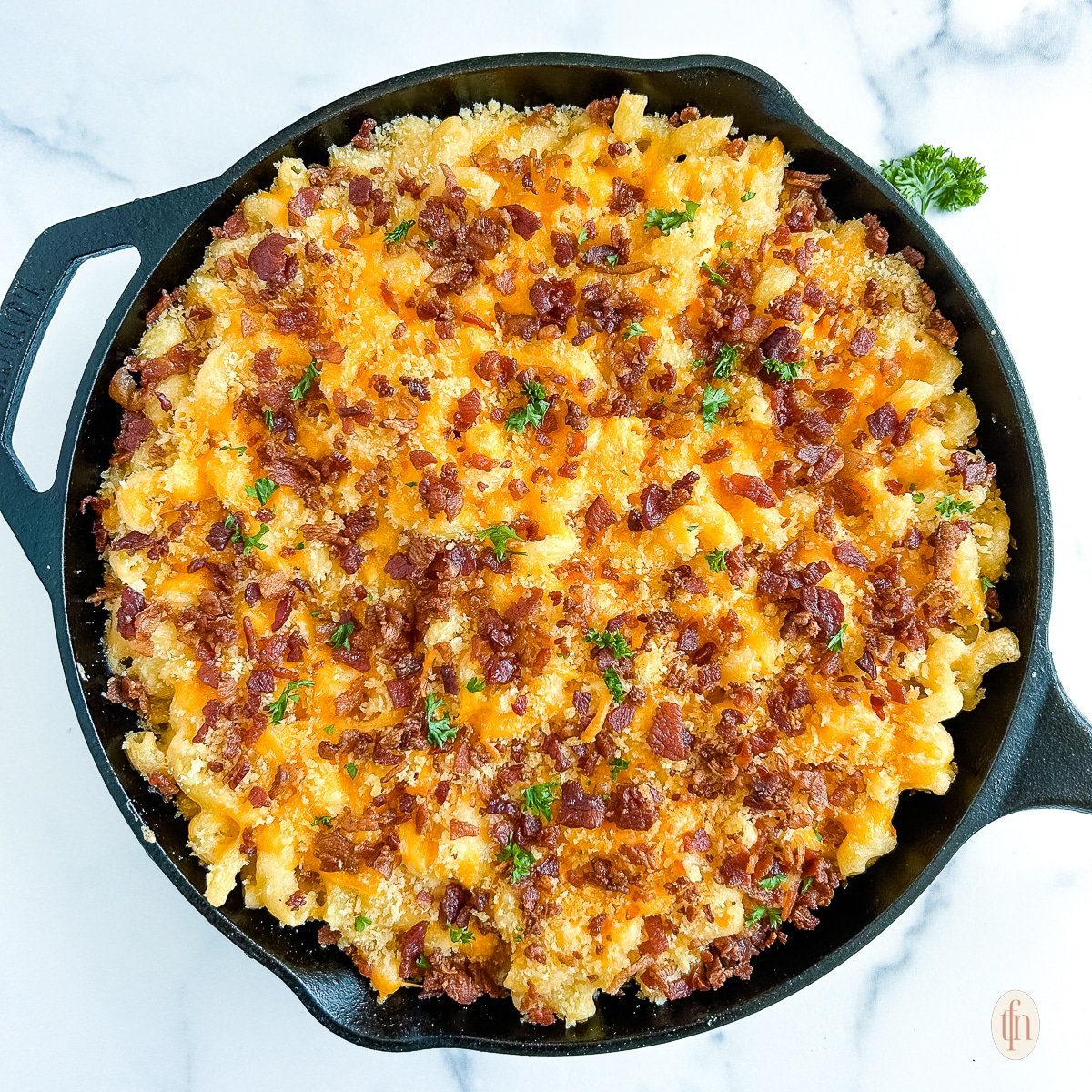 Skillet of smoked mac and cheese with bacon.