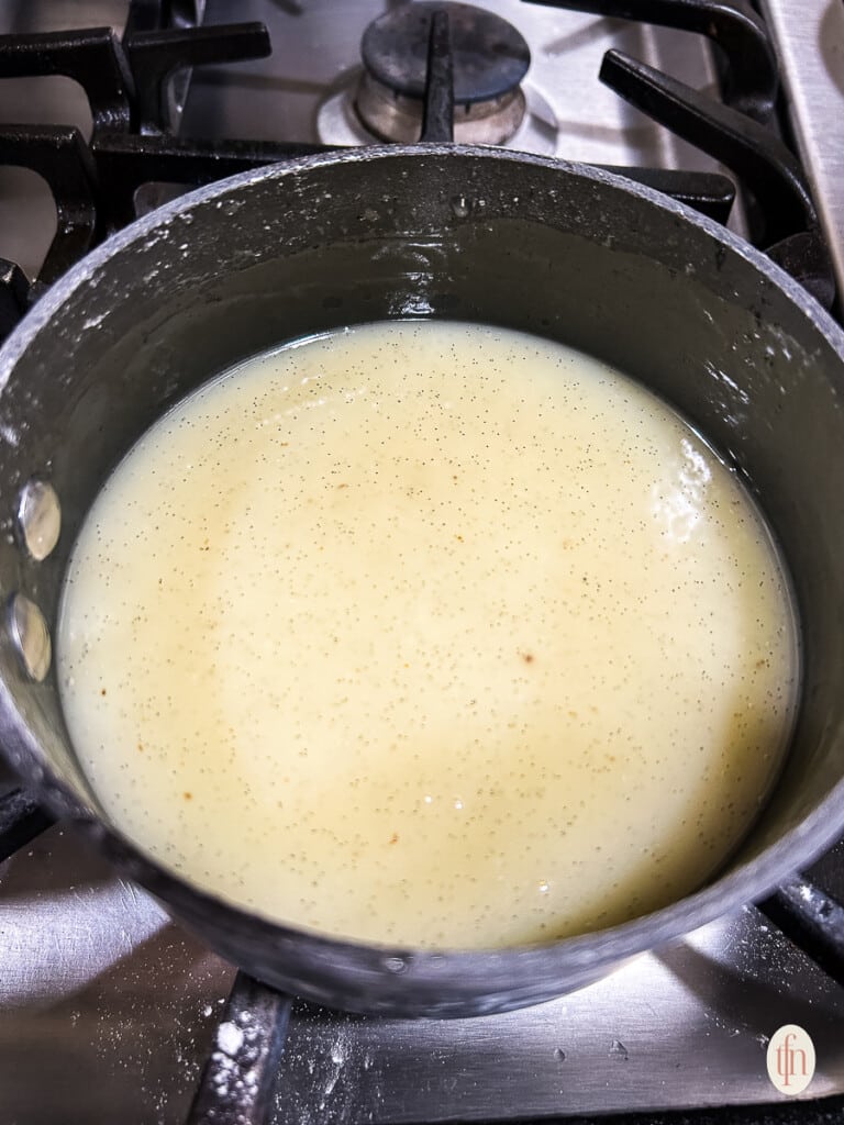 Pot of vanilla sauce on the stove. 