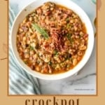 A vertical image with a brown border and autumn leaf graphics. The main image is a close-up of a bowl of thick 15 Bean Soup topped with crumbled bacon and a sprig of rosemary. The text at the bottom reads "crockpot 15 bean soup TheFeatheredNester.com".