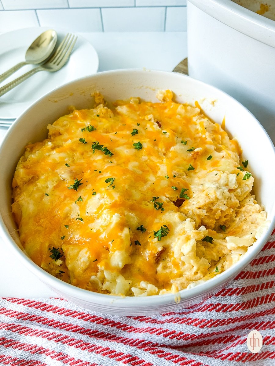 Finished dish of ccrock pot cheesy hashbrowns in a serving bowl.