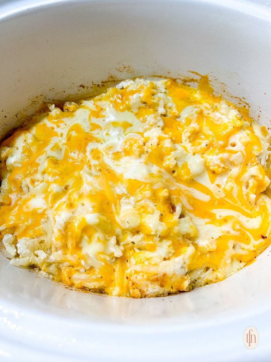 Ingredients being prepped in a bowl for crock pot cheesy hashbrown casserole.