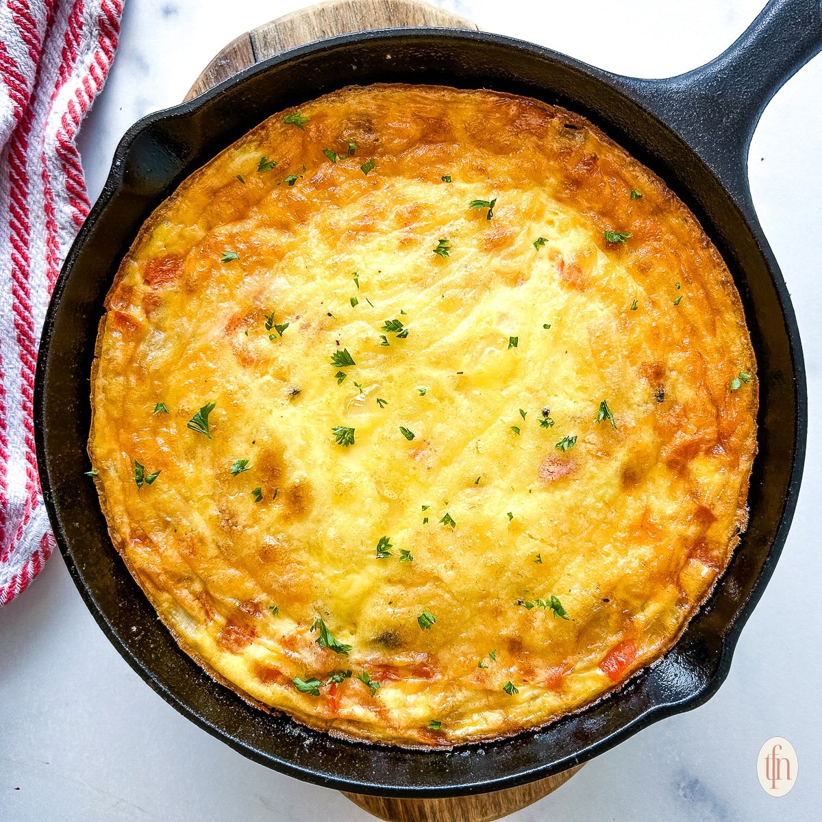 Savory egg frittata in a cast iron skillet.