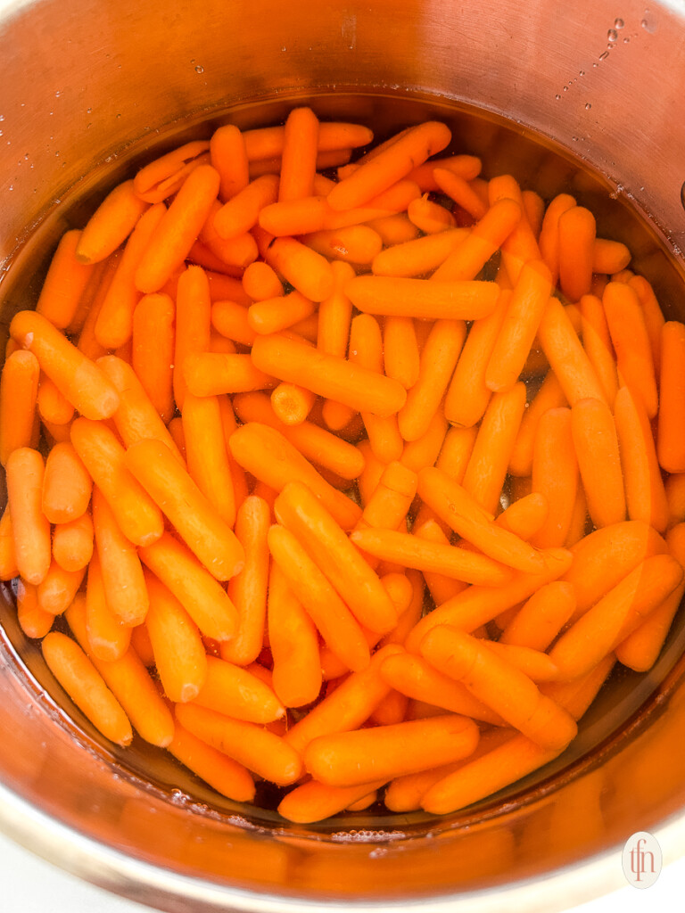 Carrots in a pot with water. 