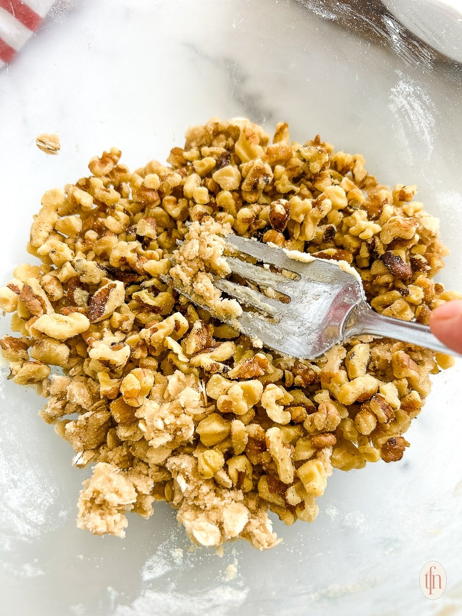 Mixing the topping with a fork in a glass bowl. 