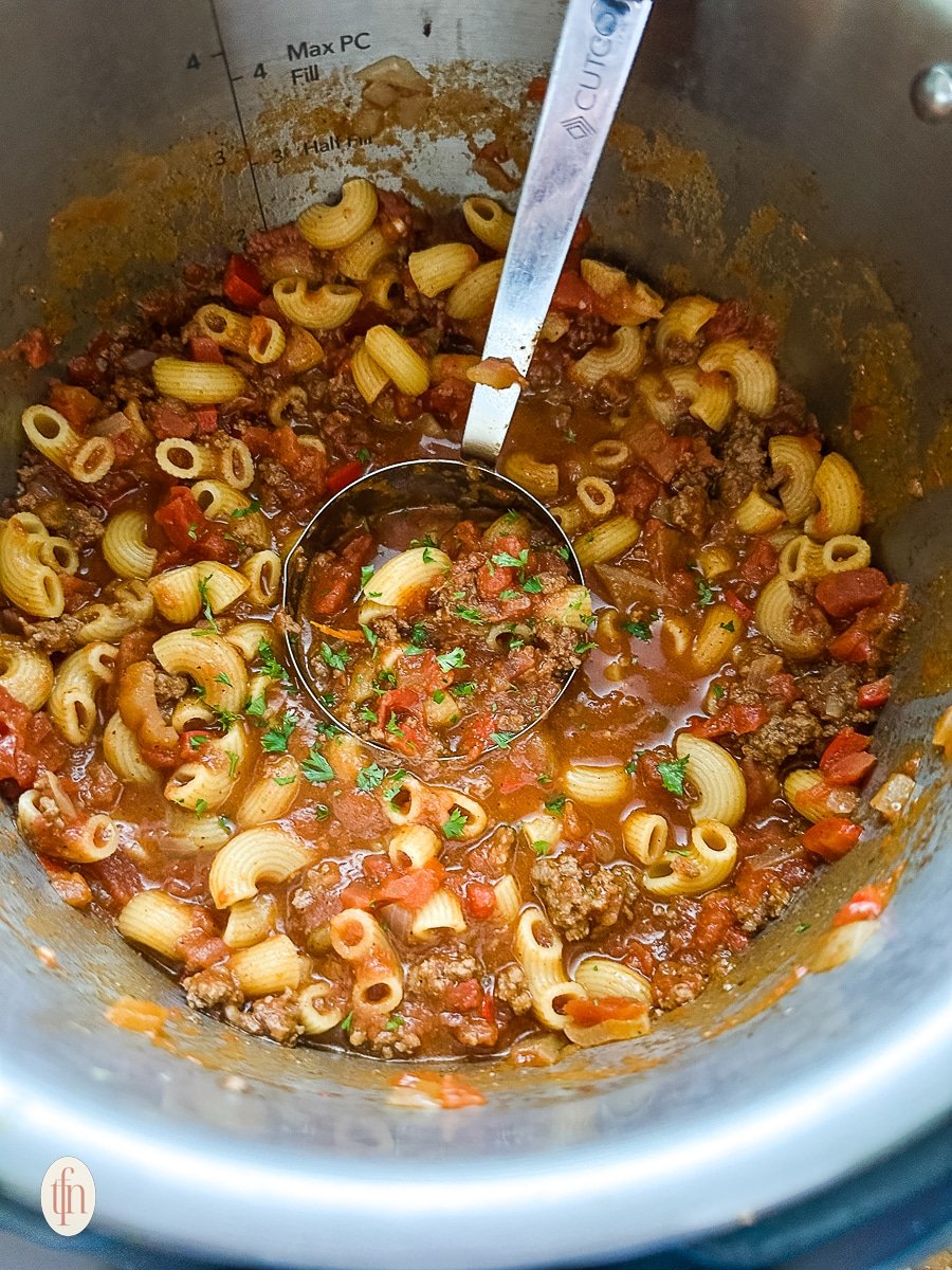 Serving ladle with chili mac in Instant Pot.