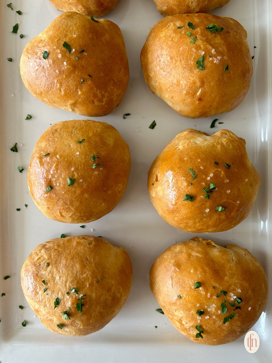 A plate of buffalo chicken bombs topped with parsley.