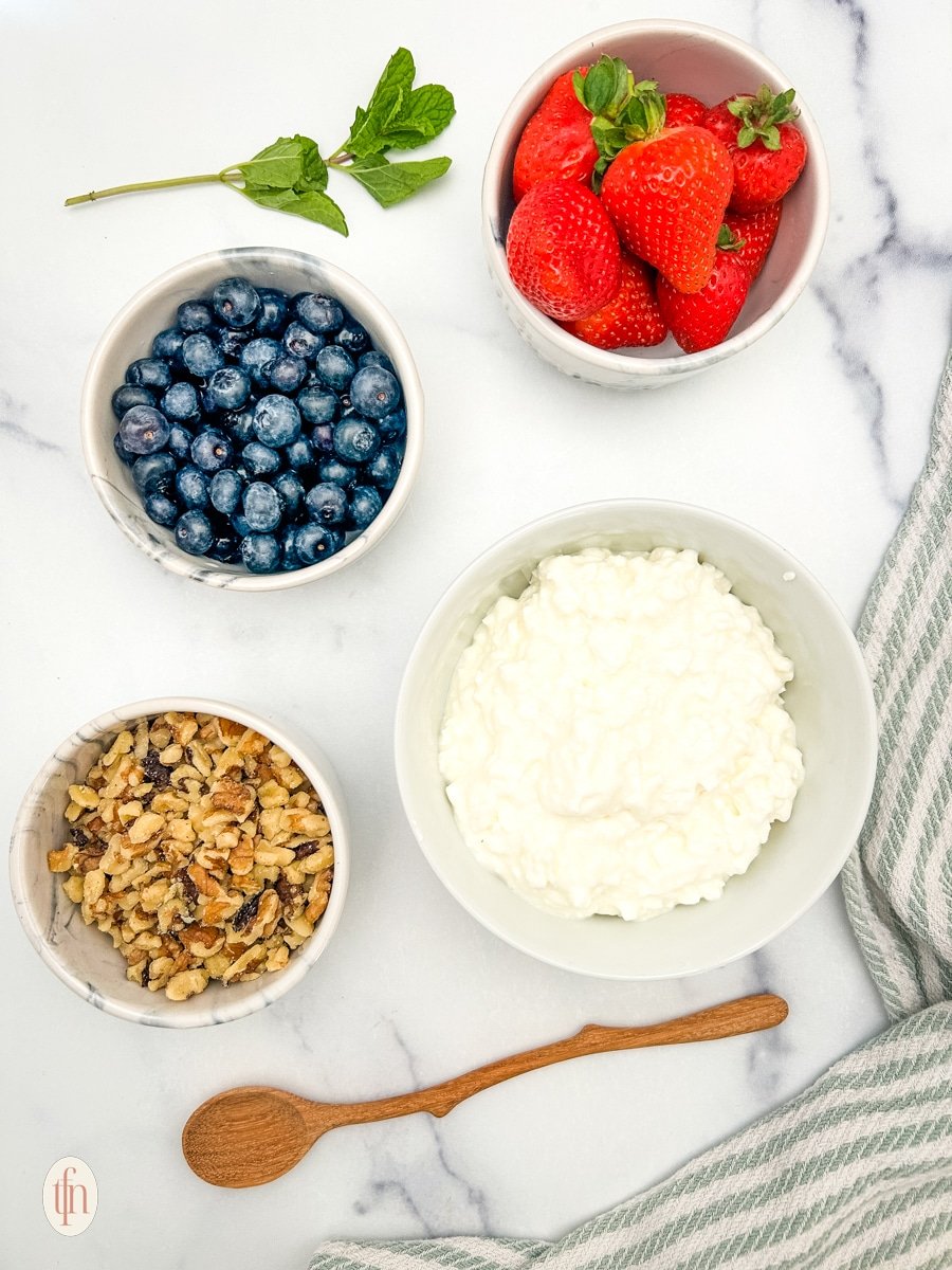 Prepared ingredients for cottage cheese and fruit bowls.