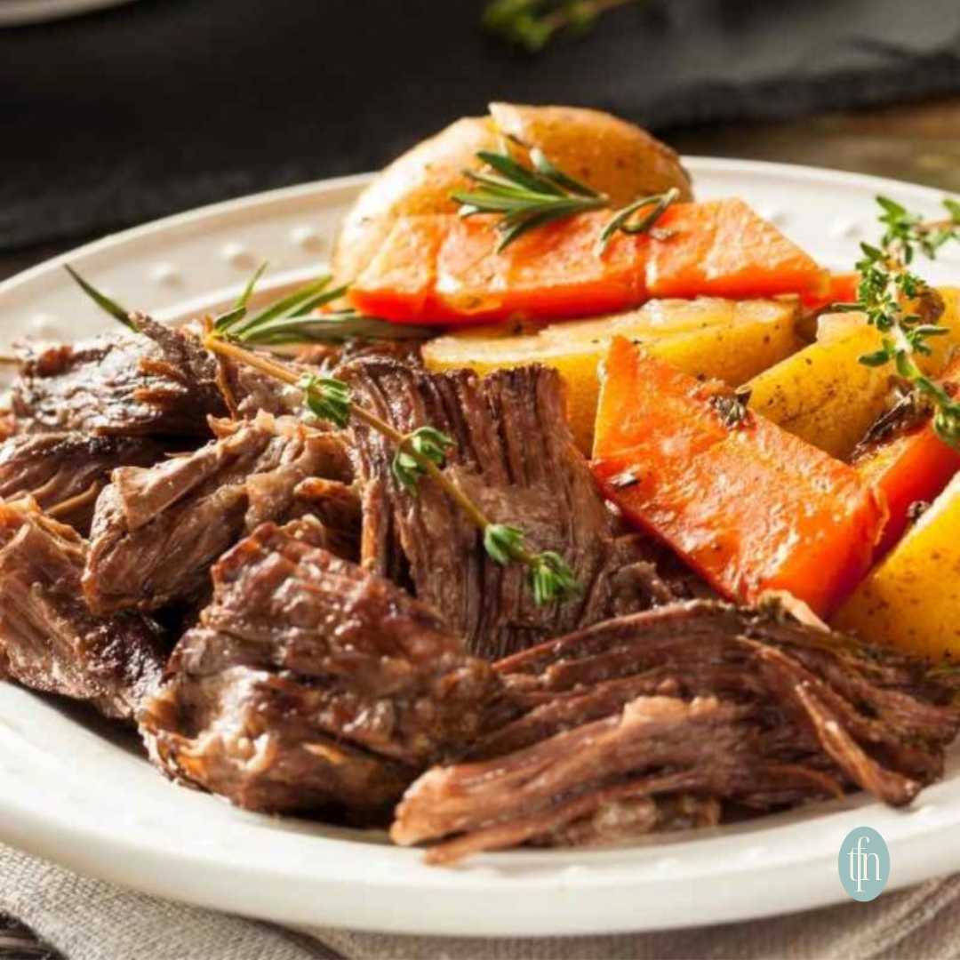 Platter full of chuck pot roast with carrots and potatoes.