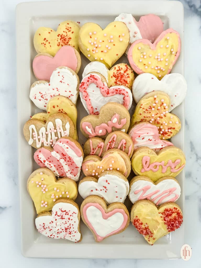 Heart sugar cookies on a white plate.