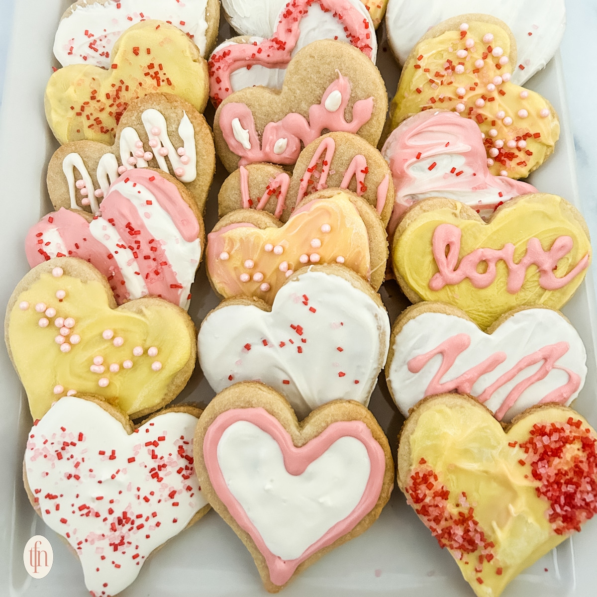 Heart sugar cookies on a white plate.