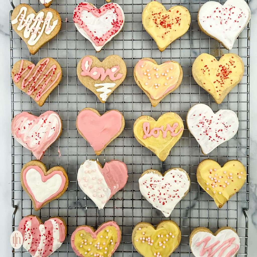 Heart sugar cookies on a cooling rack.