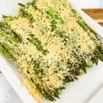 Asparagus casserole on a white serving plate.