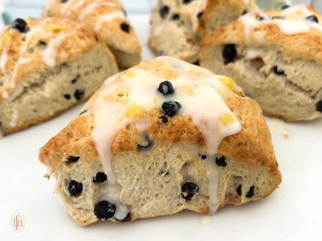 Blueberry sourdough scones on a white plate.