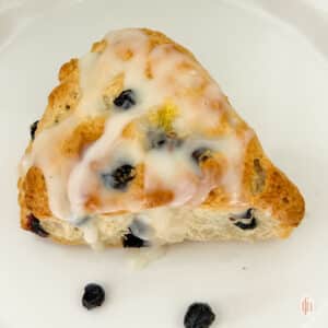 Blueberry sourdough scones on a white plate.